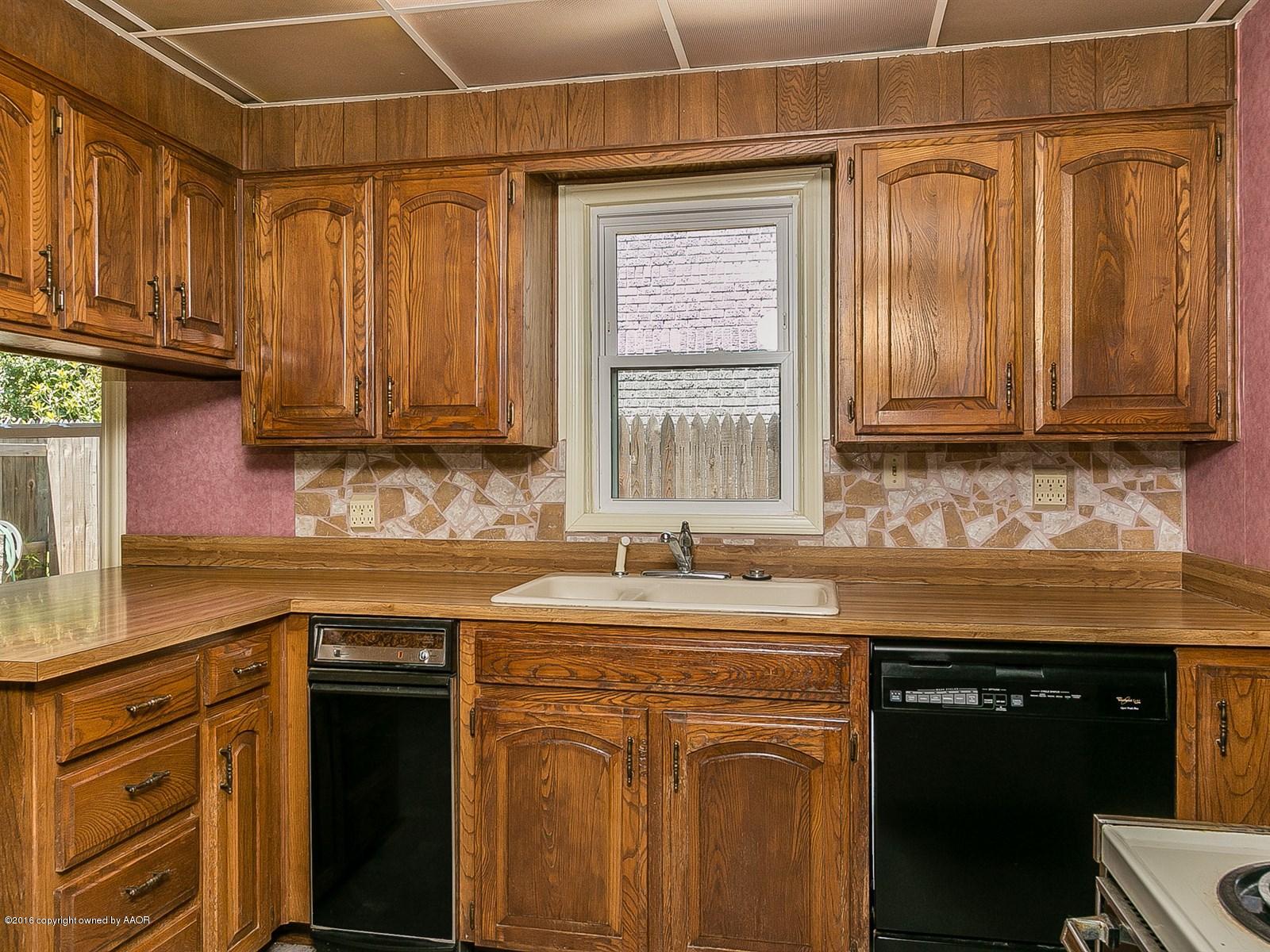1227 South Bonham Street Amarillo, TX 79102 - Photo 10 of 25 a kitchen with stainless steel appliances granite countertop a sink stove and cabinets