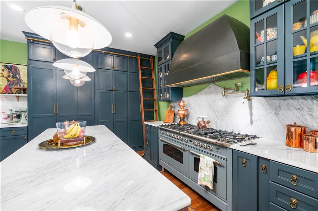 311 Derry Ridge Road Ligonier, PA 15658 - Photo 11 of 35 A 60-inch ILVE Italian gas range anchors a culinary space finished in hand-selected marble countertops and an artisan backsplash — functional grandeur that honors the tradition of great European kitchens.