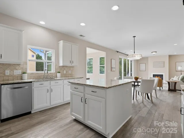 a kitchen with center island table and chairs in it
