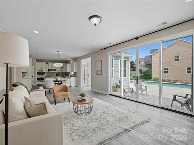 a living room with furniture and view of kitchen