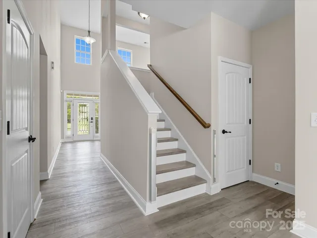 a view of a hallway with wooden floor and entryway