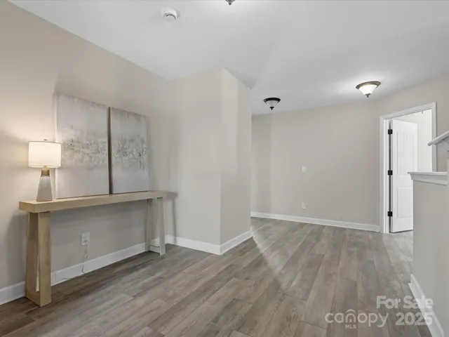 a view of a kitchen with wooden floor and a sink
