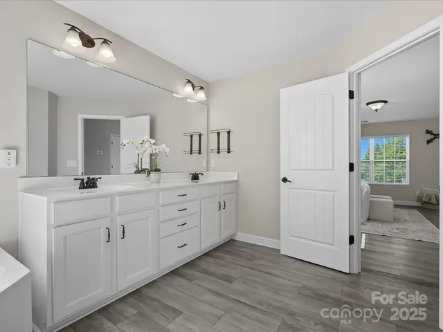 a spacious bathroom with double vanity sink and a mirror