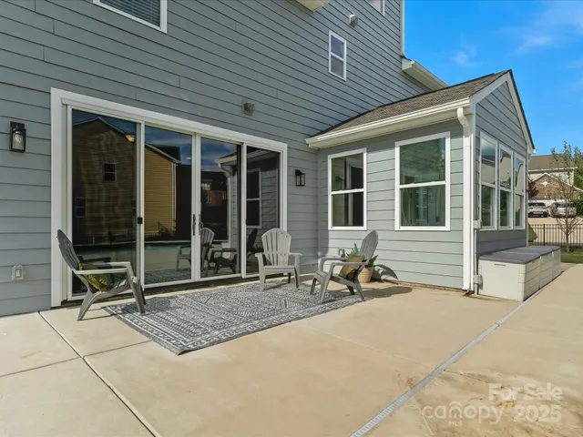 a building outdoor space with patio furniture and garden