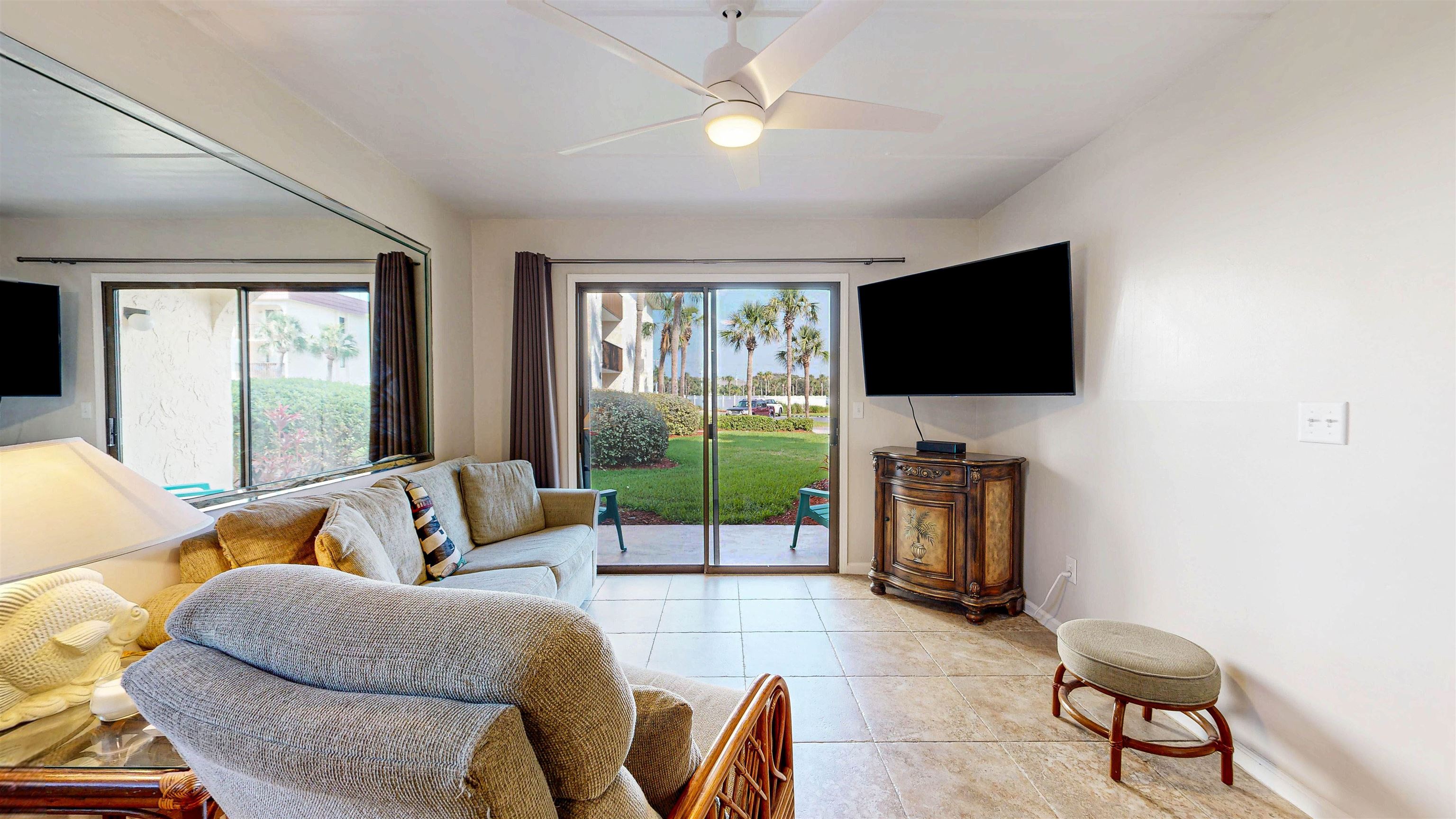 880 A1A Beach Boulevard, Unit 6101 St. Augustine, FL 32080 - Photo 6 of 21 a living room with furniture and a flat screen tv