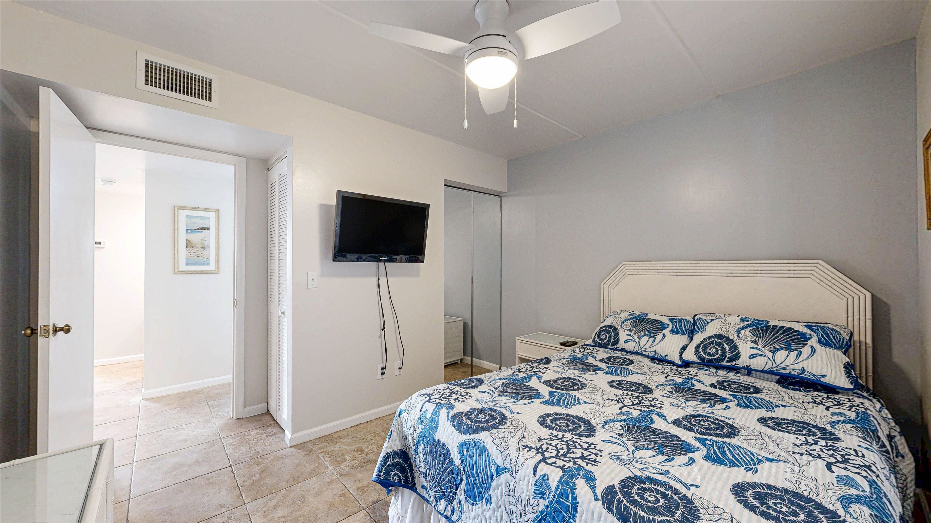 880 A1A Beach Boulevard, Unit 6101 St. Augustine, FL 32080 - Photo 10 of 21 a bedroom with a bed and a flat screen tv