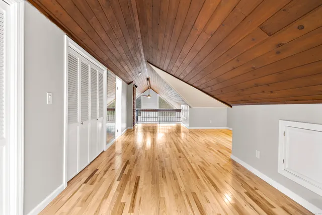 a view of backyard with wooden floor and fence