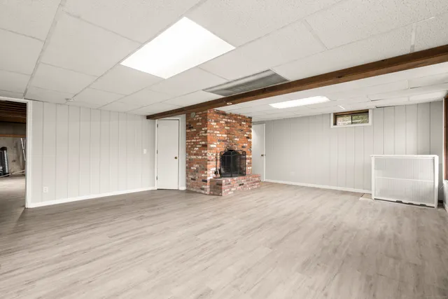 a view of a livingroom with wooden floor and a large window