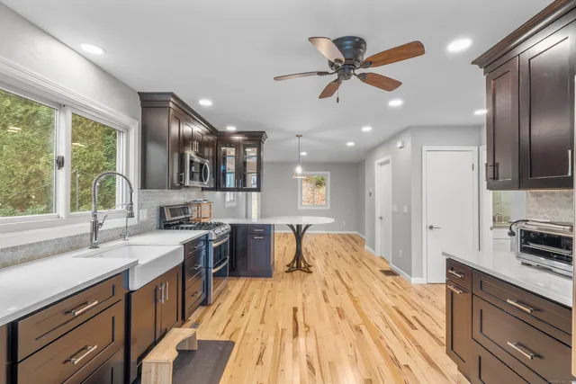 a kitchen with stainless steel appliances a refrigerator and a stove top oven