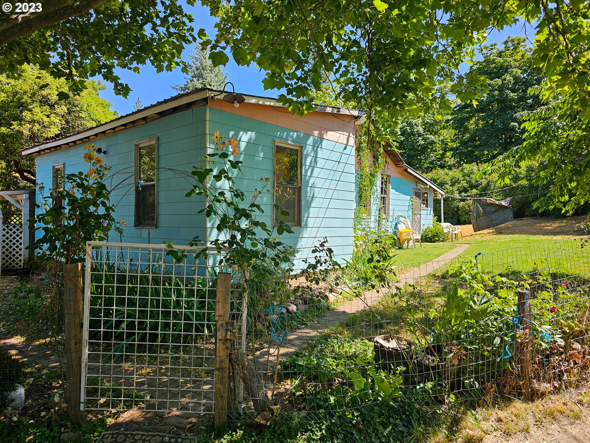 1805 Shoestring Road Riddle, OR 97469 - Photo 3 of 30 a view of a house with a garden
