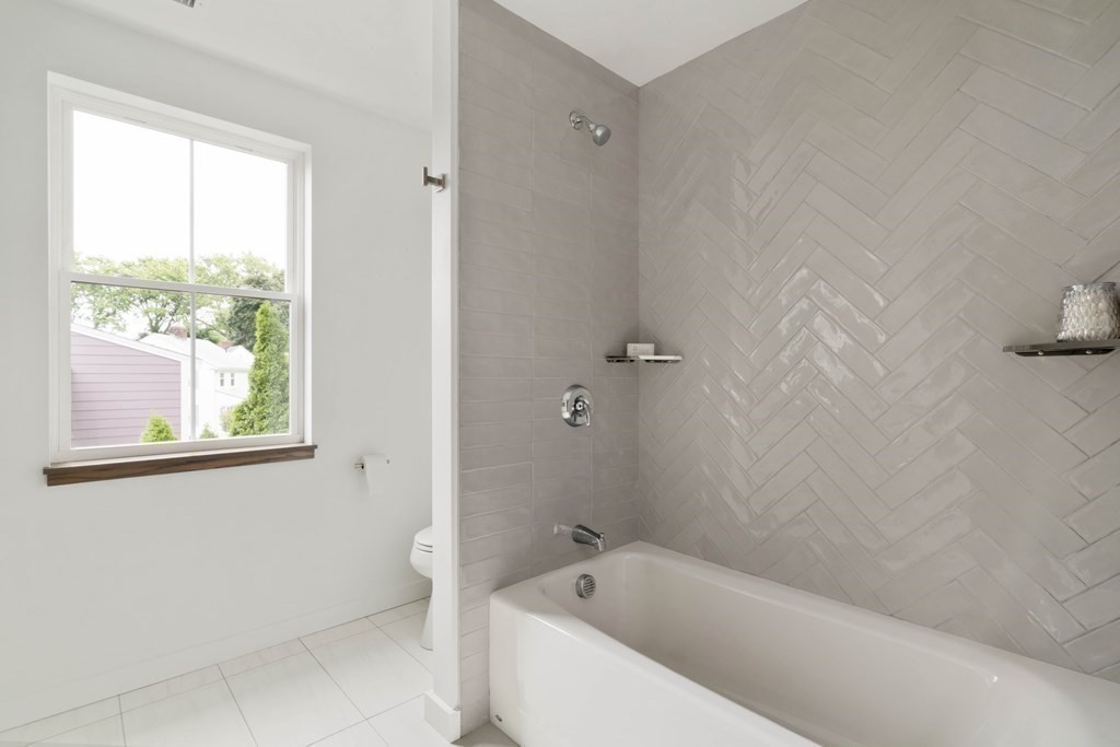 51 Eliot Road Arlington, MA 02474 - Photo 14 of 42 a bathroom with a bathtub and window