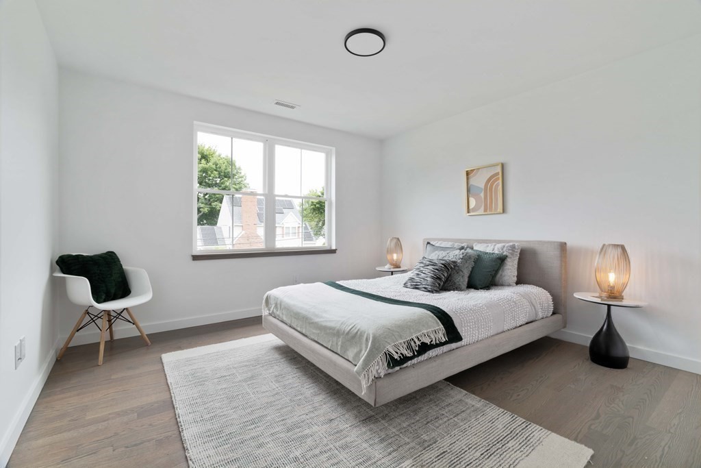 51 Eliot Road Arlington, MA 02474 - Photo 18 of 42 a bedroom with a bed lamp and a window
