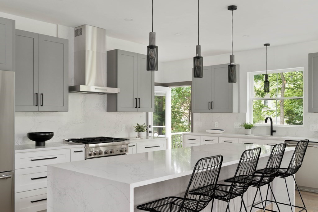 51 Eliot Road Arlington, MA 02474 - Photo 2 of 42 a kitchen with stainless steel appliances kitchen island a table chairs and a sink