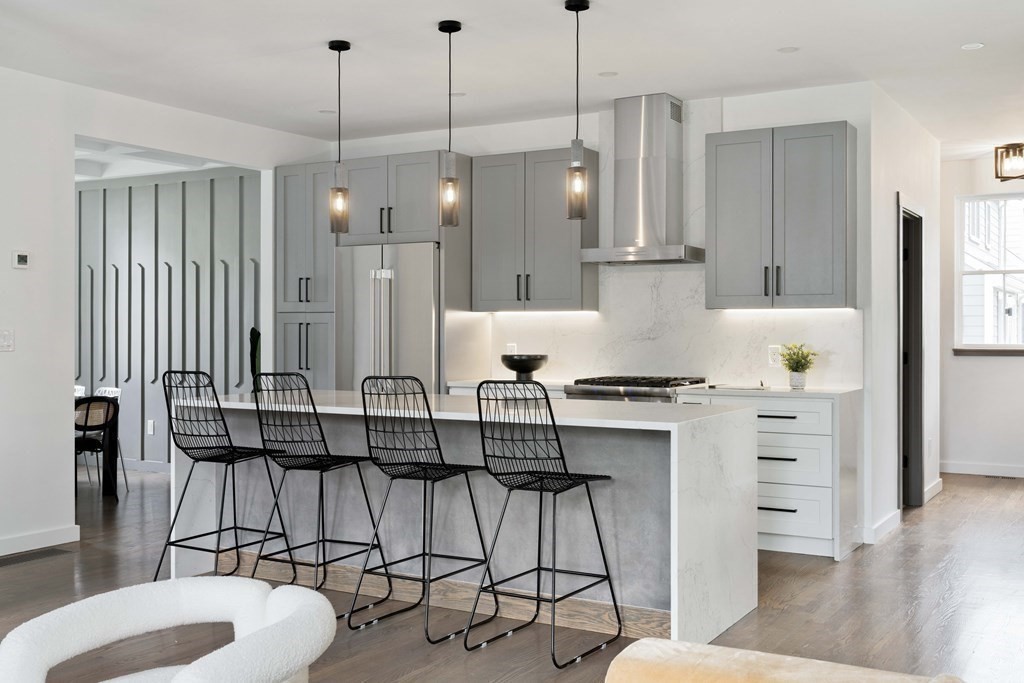 51 Eliot Road Arlington, MA 02474 - Photo 28 of 42 a kitchen with stainless steel appliances granite countertop a stove a refrigerator and a view of living room