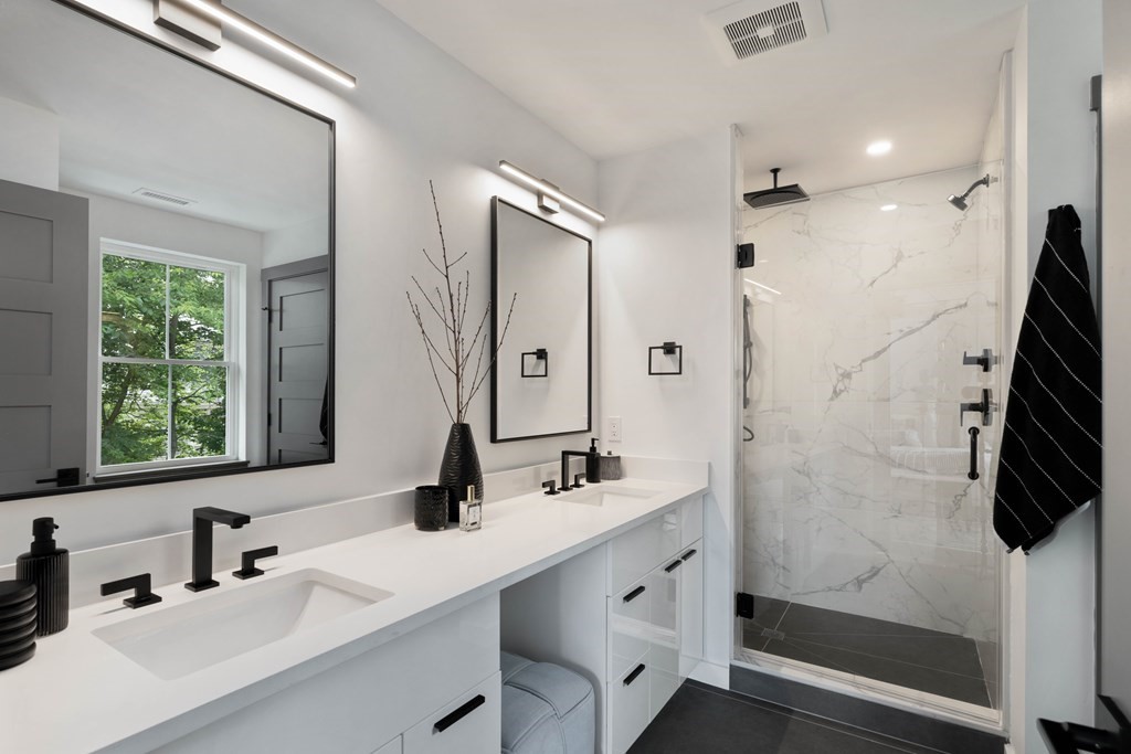 51 Eliot Road Arlington, MA 02474 - Photo 38 of 42 a bathroom with a double vanity sink a toilet a mirror and shower