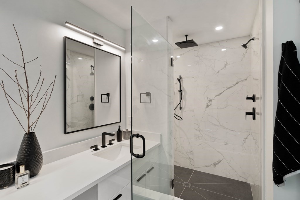 51 Eliot Road Arlington, MA 02474 - Photo 40 of 42 a bathroom with a shower sink and mirror