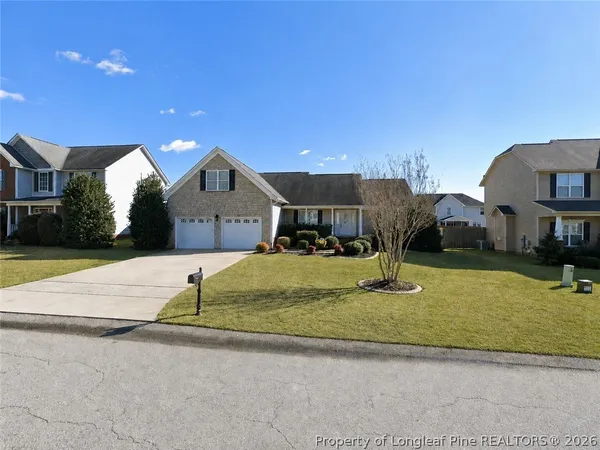 a front view of a house with a yard and garage