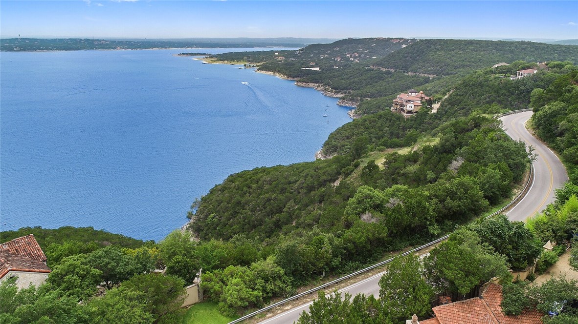 an aerial view of a house with a garden and mountain view