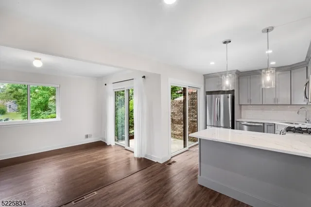 a large white kitchen with a large window