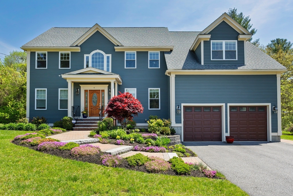 6 MacIntosh Road Bedford, MA 01730 - Photo 1 of 1 a front view of a house with a yard and garage