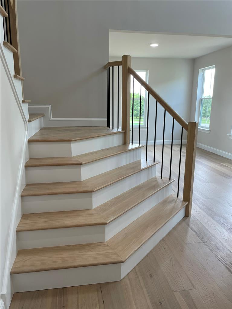 5043 Chapmans Road Orefield, PA 18069 - Photo 11 of 30 A graceful staircase with natural wood treads and elegant iron balusters defines this welcoming entry.