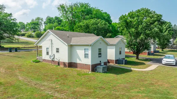 a view of a house with pool and a yard