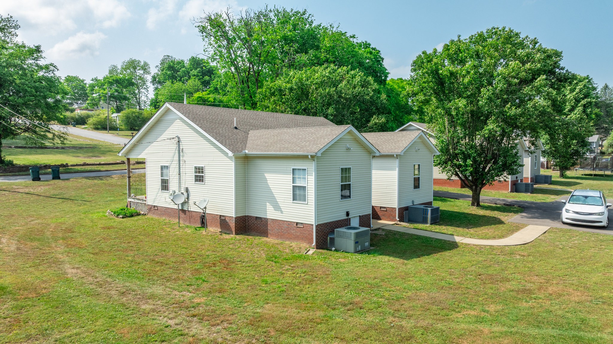 a view of a house with pool and a yard