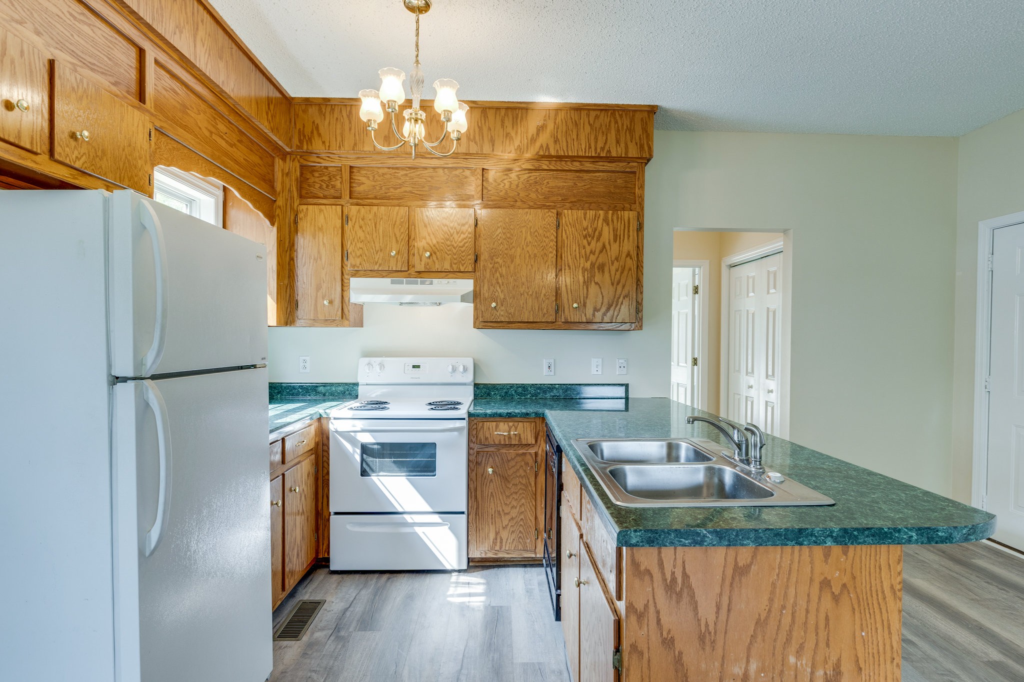 225 Locust Street Pulaski, TN 38478 - Photo 17 of 44 a kitchen with stainless steel appliances granite countertop a sink stove and refrigerator