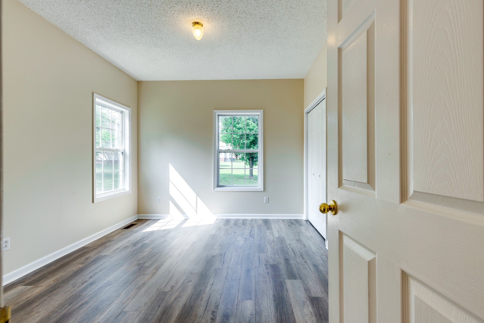 225 Locust Street Pulaski, TN 38478 - Photo 20 of 44 a view of an empty room with a window and wooden floor