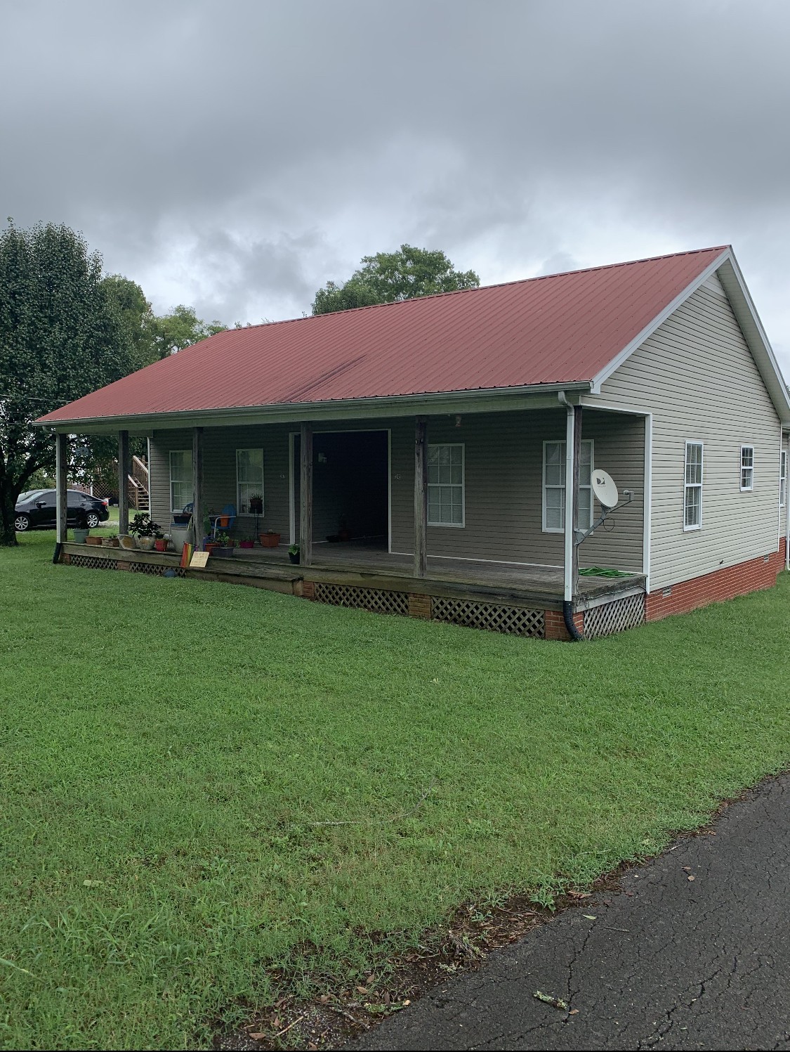 225 Locust Street Pulaski, TN 38478 - Photo 2 of 2 a front view of a house with a garden and trees