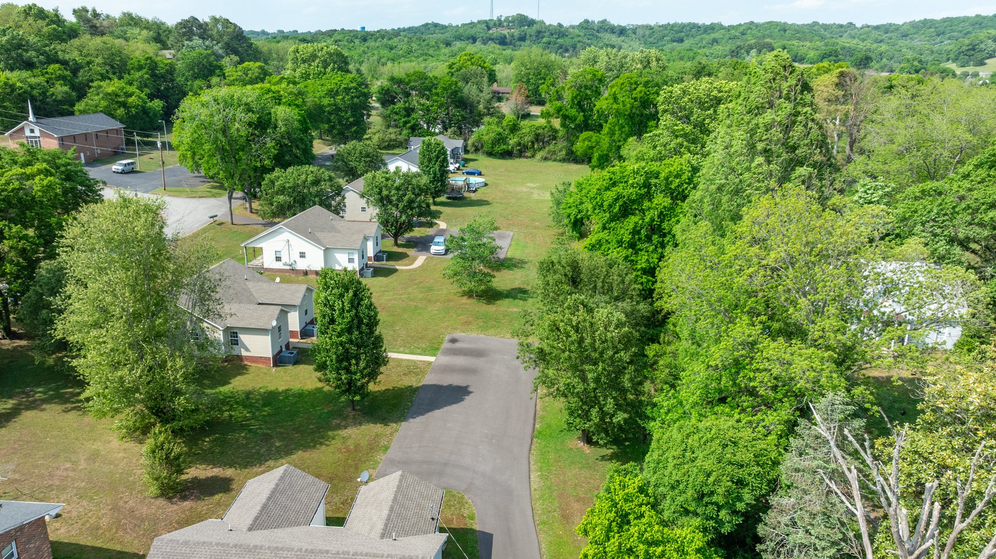 225 Locust Street Pulaski, TN 38478 - Photo 42 of 44 an aerial view of residential house with outdoor space and trees all around