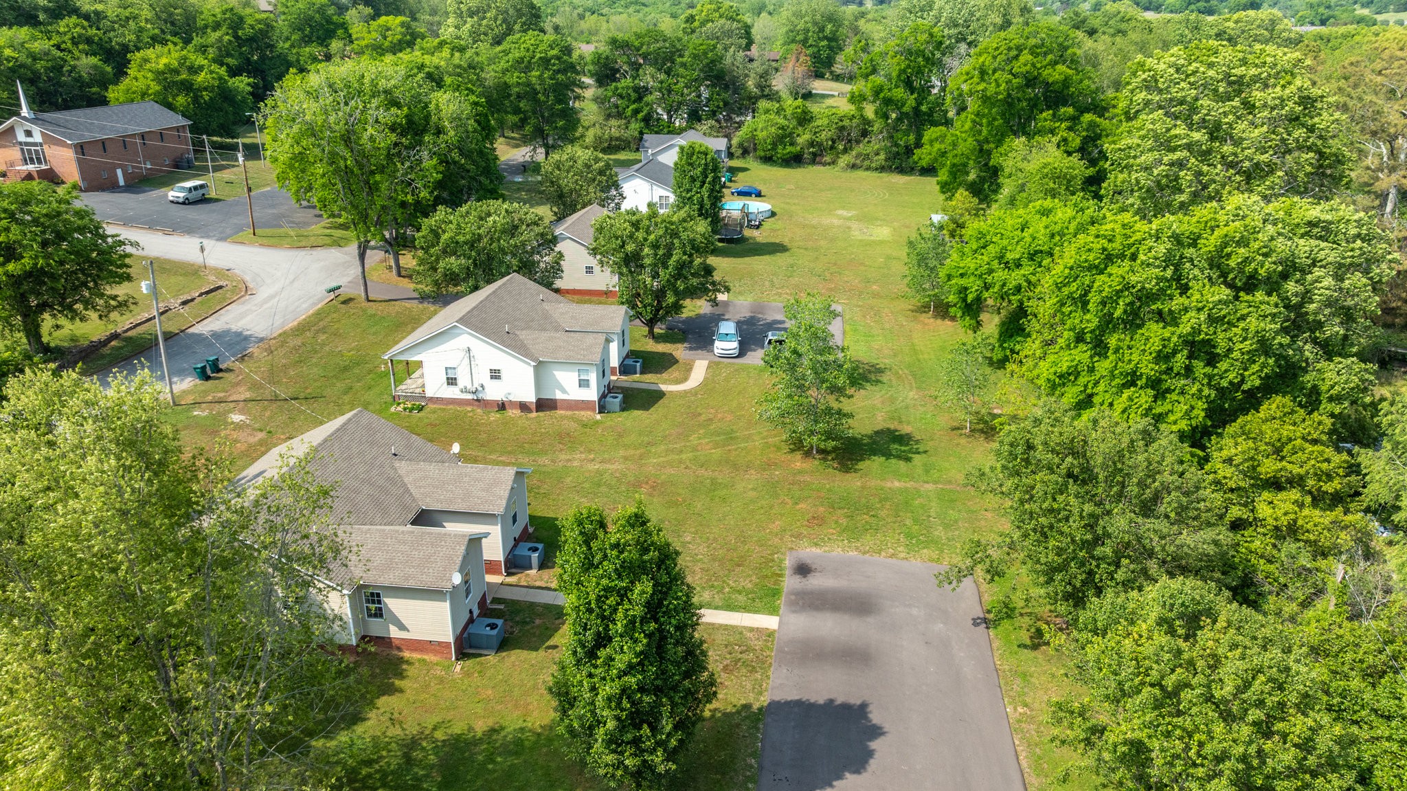 225 Locust Street Pulaski, TN 38478 - Photo 43 of 44 an aerial view of a house with a garden and lake view