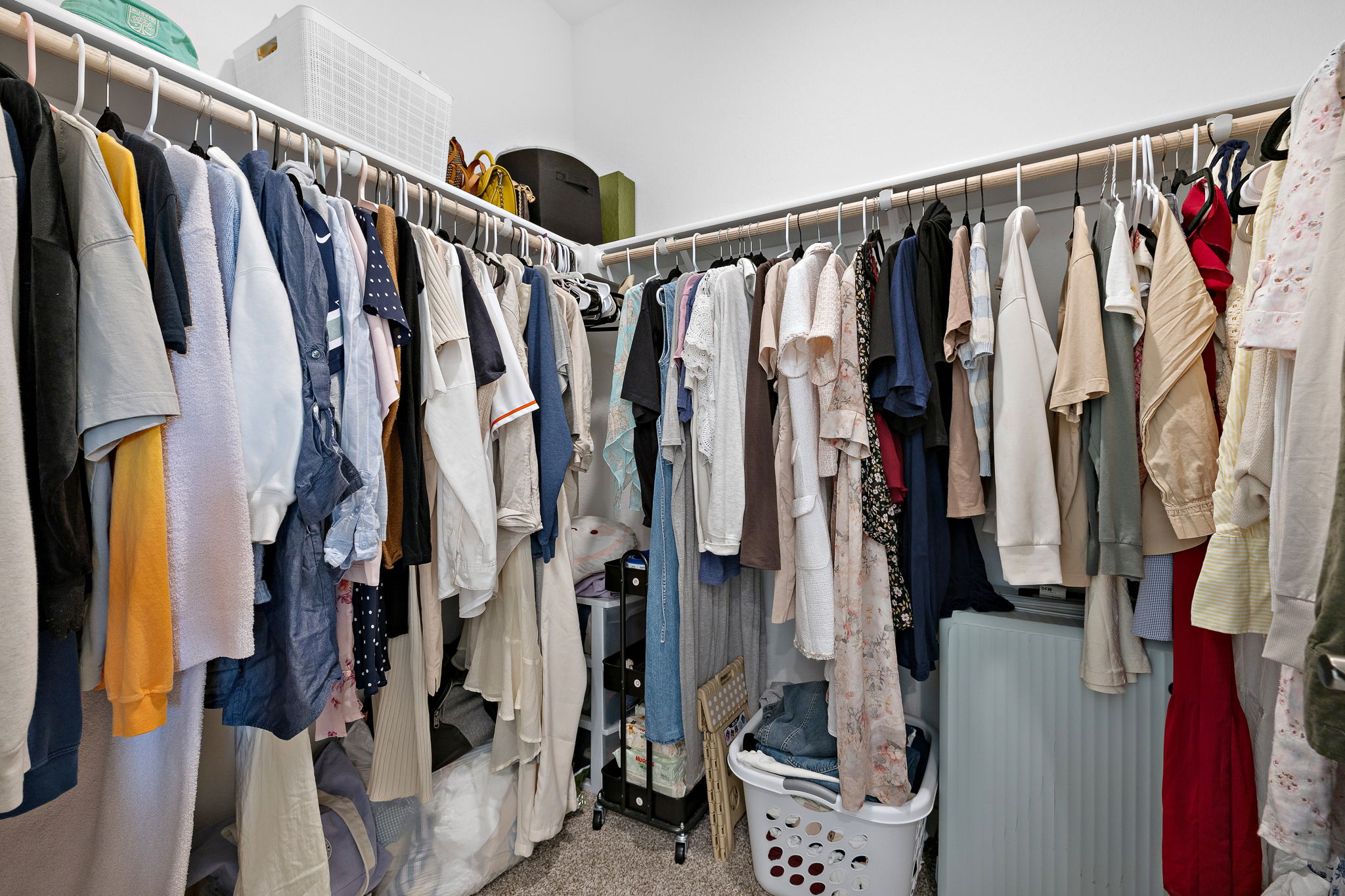 2313 Ranier Court Austin, TX 78754 - Photo 14 of 22 a view of walk in closet with clothes and shoes