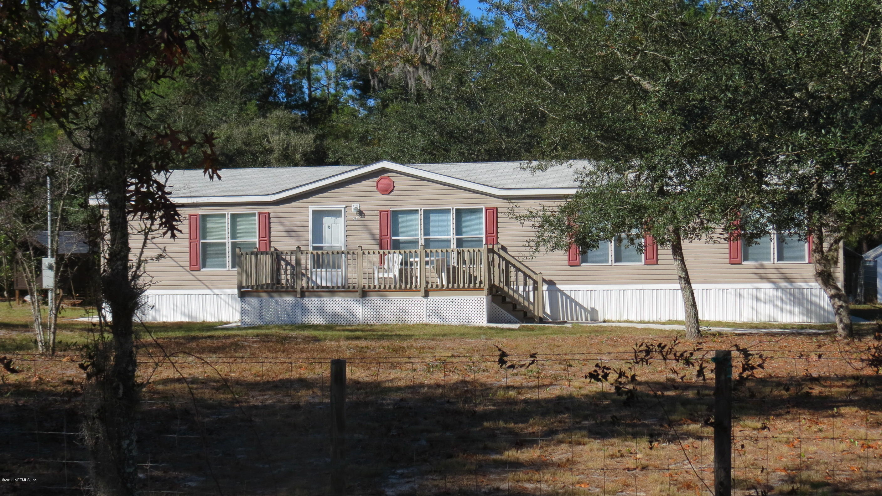 284 Beecher Springs Road Welaka, FL 32112 - Photo 1 of 36 a front view of a house with a yard