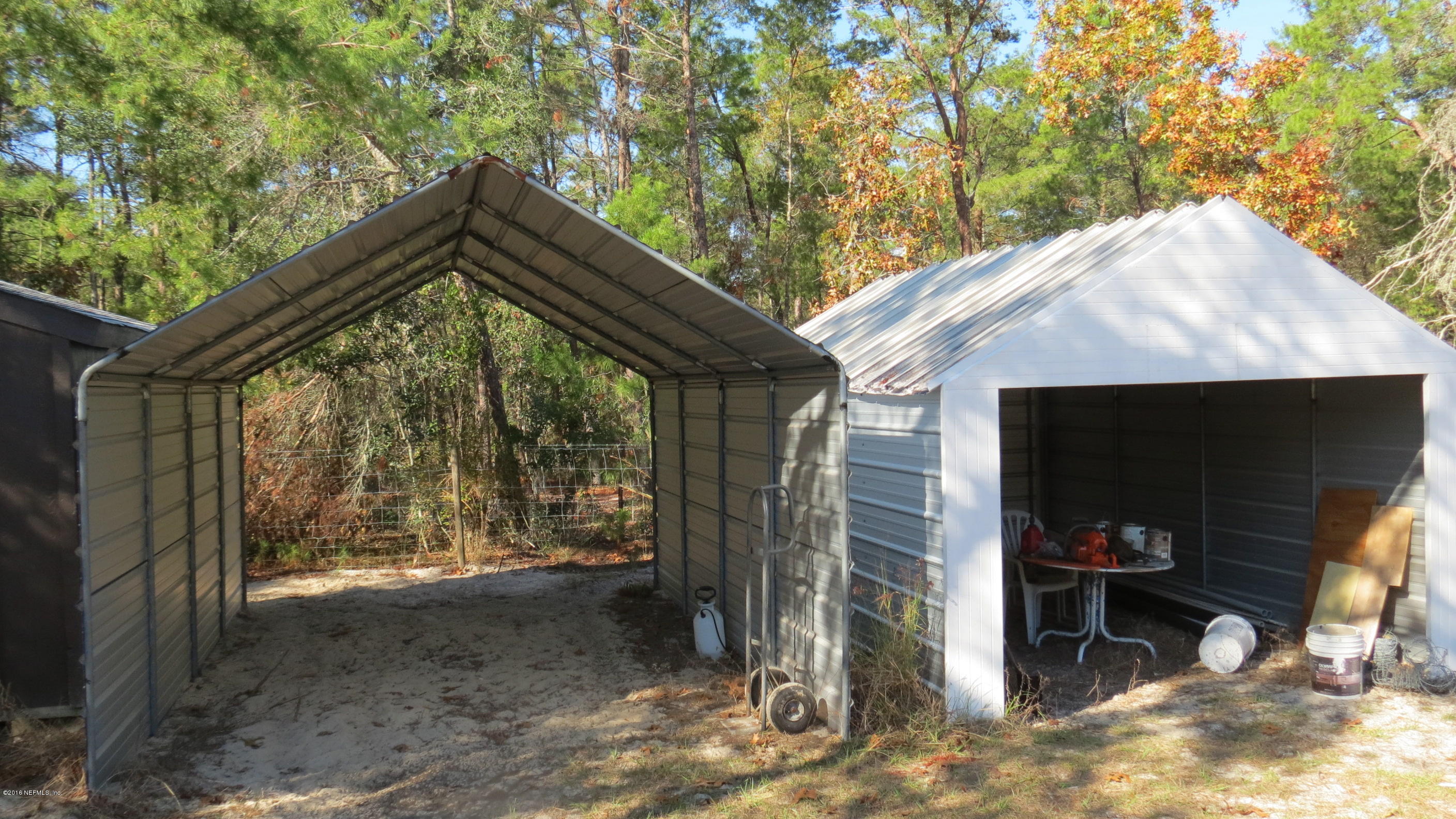 284 Beecher Springs Road Welaka, FL 32112 - Photo 18 of 36 a backyard of a house with barbeque oven and table