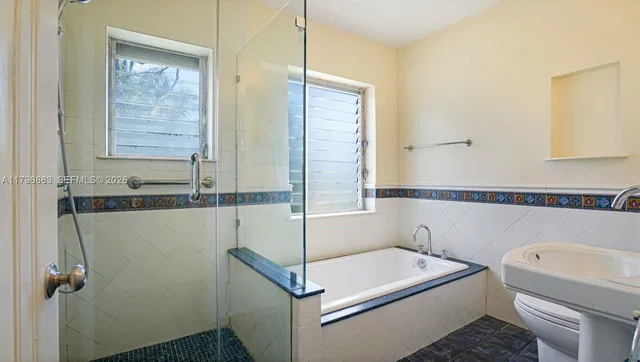 a bathroom with a sink a toilet and tub