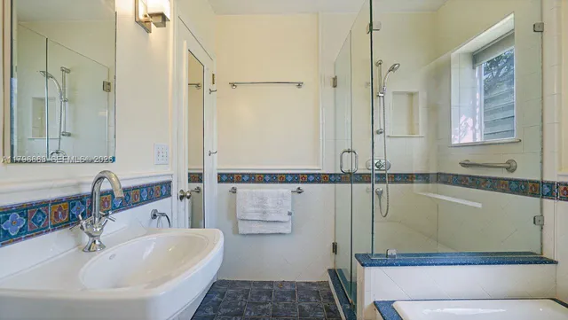 a bathroom with a tub sink and mirror