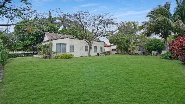 a front view of house with yard and green space
