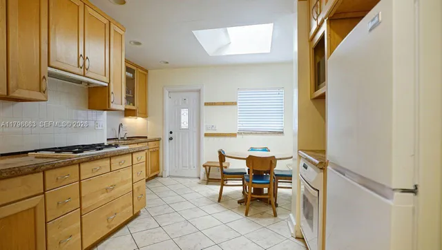 a kitchen with stainless steel appliances kitchen island granite countertop a sink and cabinets