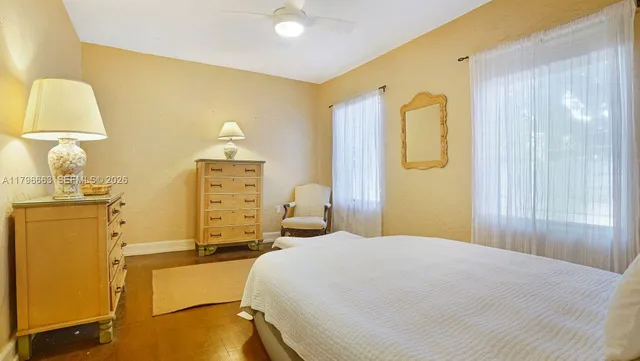 a bedroom with a bed and dresser with mirror