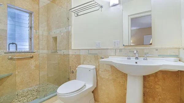 a bathroom with a sink toilet and shower