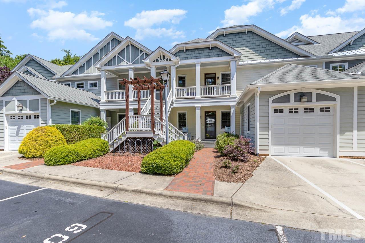 511 Hillsborough Street, Unit 106 Chapel Hill, NC 27514 - Photo 1 of 25 a front view of a house with a garden and plants