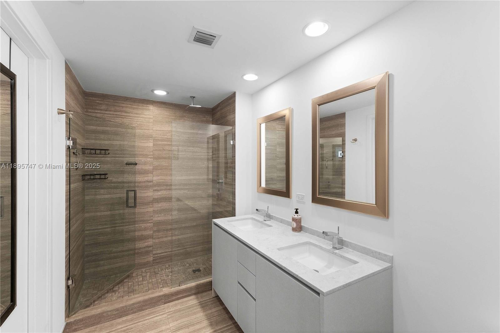 1010 Brickell Avenue, Unit 3208 Miami, FL 33131 - Photo 12 of 15 a bathroom with a shower sink and mirror