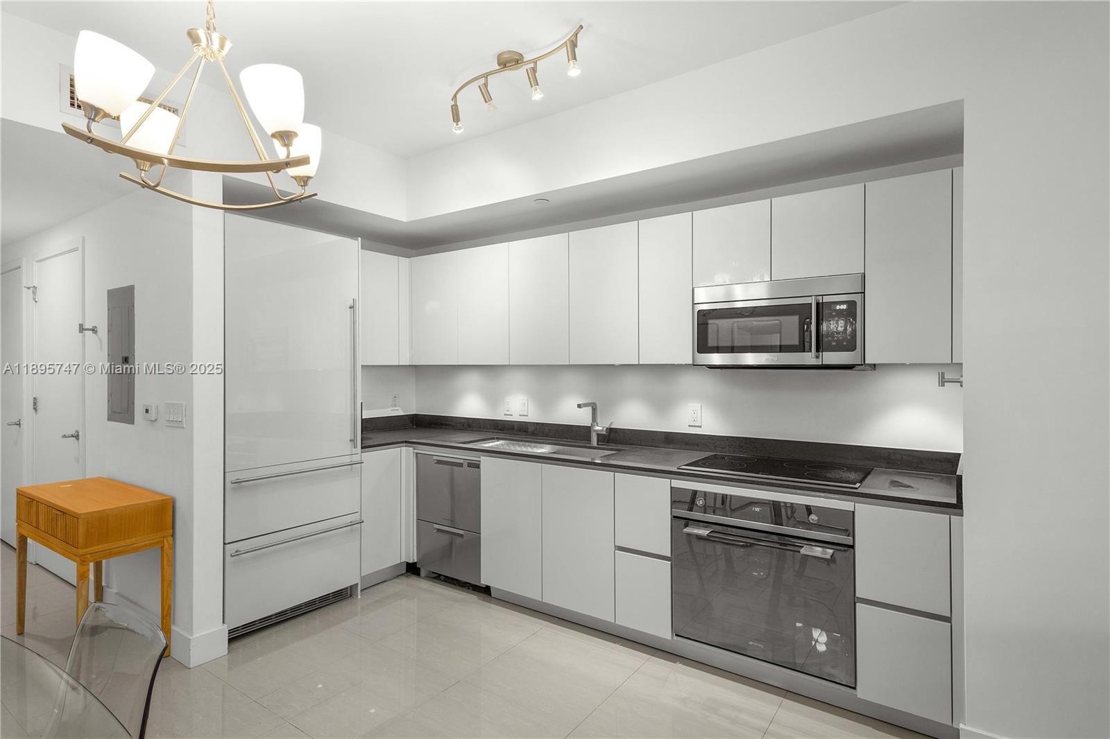 1010 Brickell Avenue, Unit 3208 Miami, FL 33131 - Photo 8 of 15 a kitchen with kitchen island granite countertop cabinets and stainless steel appliances