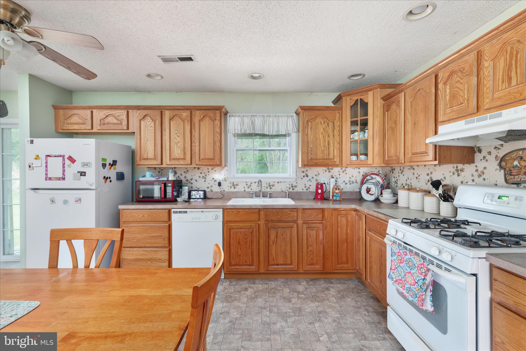 205 Clyde Borum Road Inwood, WV 25428 - Photo 11 of 46 a kitchen with stainless steel appliances granite countertop a stove a sink dishwasher and a refrigerator with cabinets