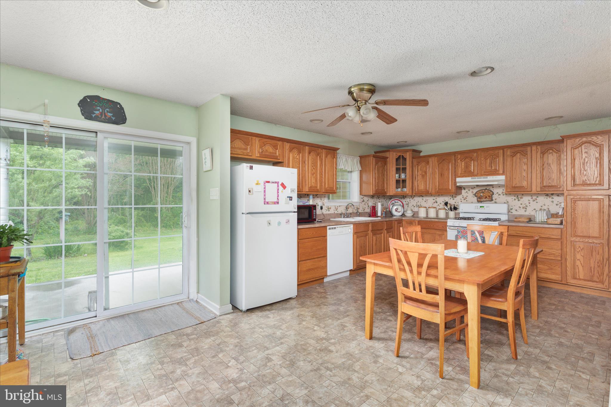 205 Clyde Borum Road Inwood, WV 25428 - Photo 12 of 46 a dining room with stainless steel appliances a table and chairs