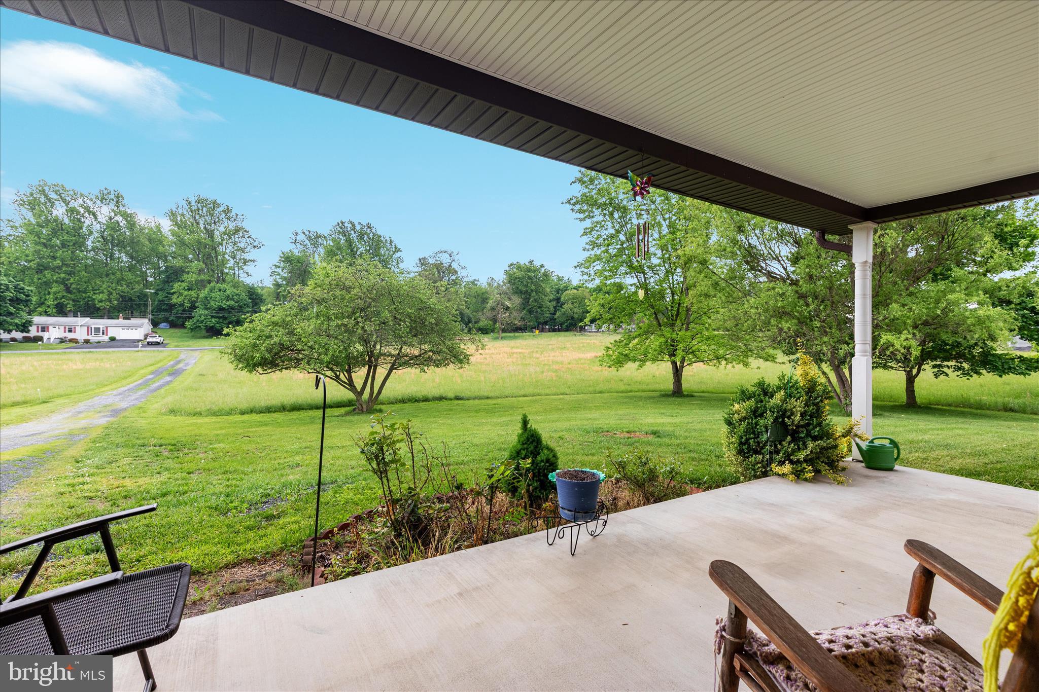 205 Clyde Borum Road Inwood, WV 25428 - Photo 30 of 46 a view of a patio with lawn chairs floor to ceiling window and yard