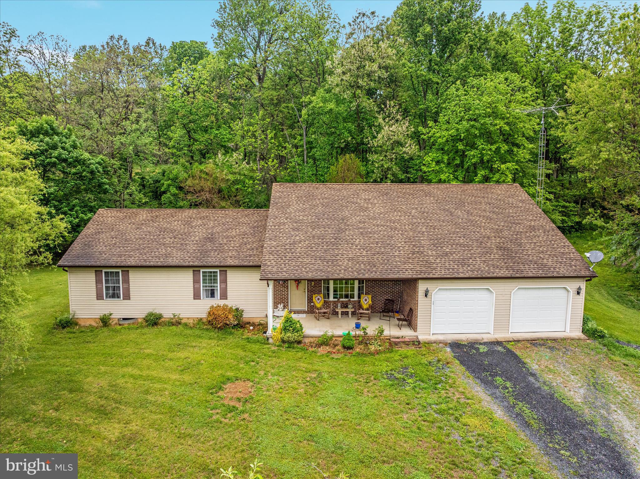 205 Clyde Borum Road Inwood, WV 25428 - Photo 34 of 46 a front view of a house with a garden and trees