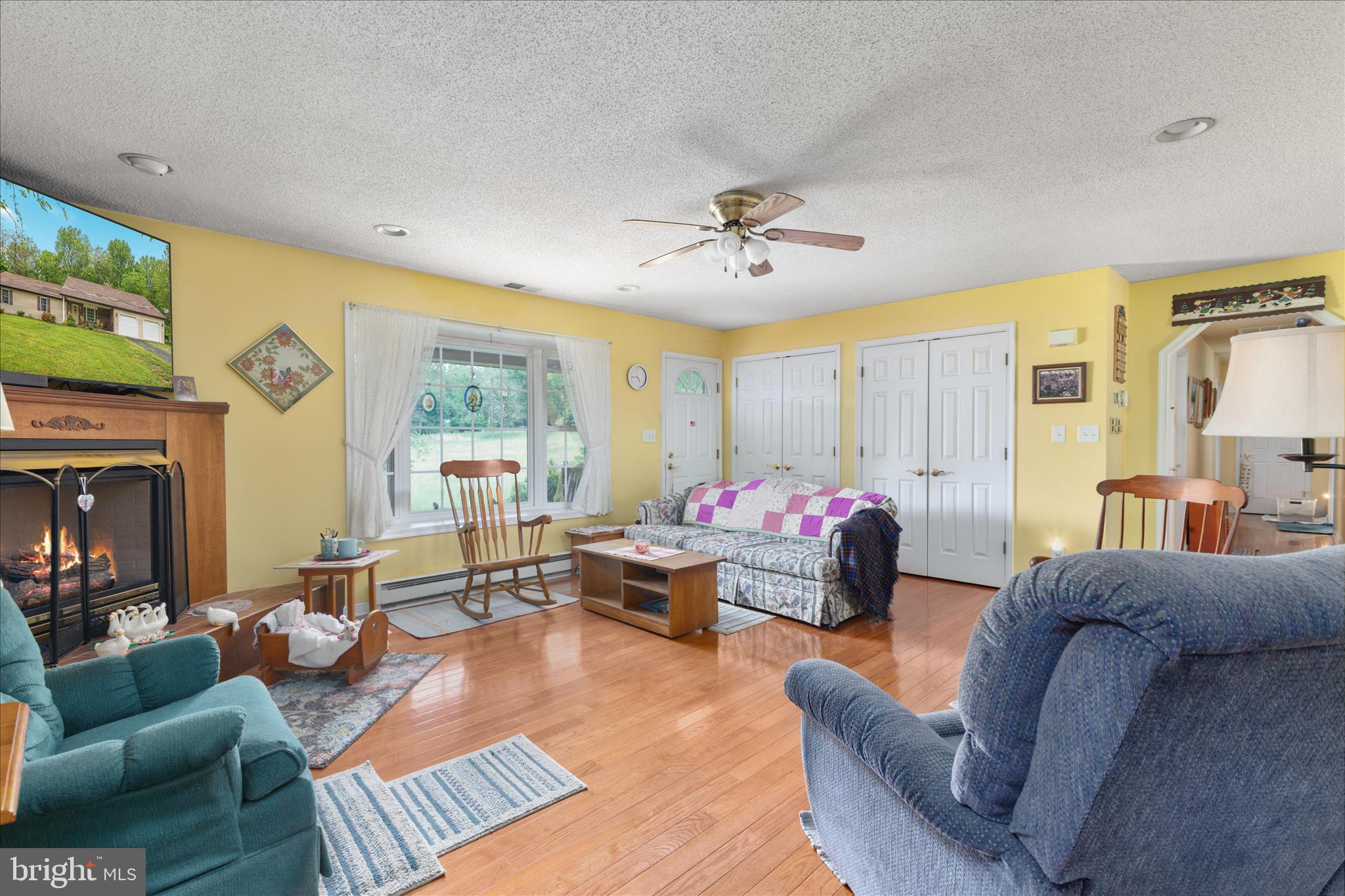 205 Clyde Borum Road Inwood, WV 25428 - Photo 6 of 46 a living room with furniture or couch and a flat screen tv