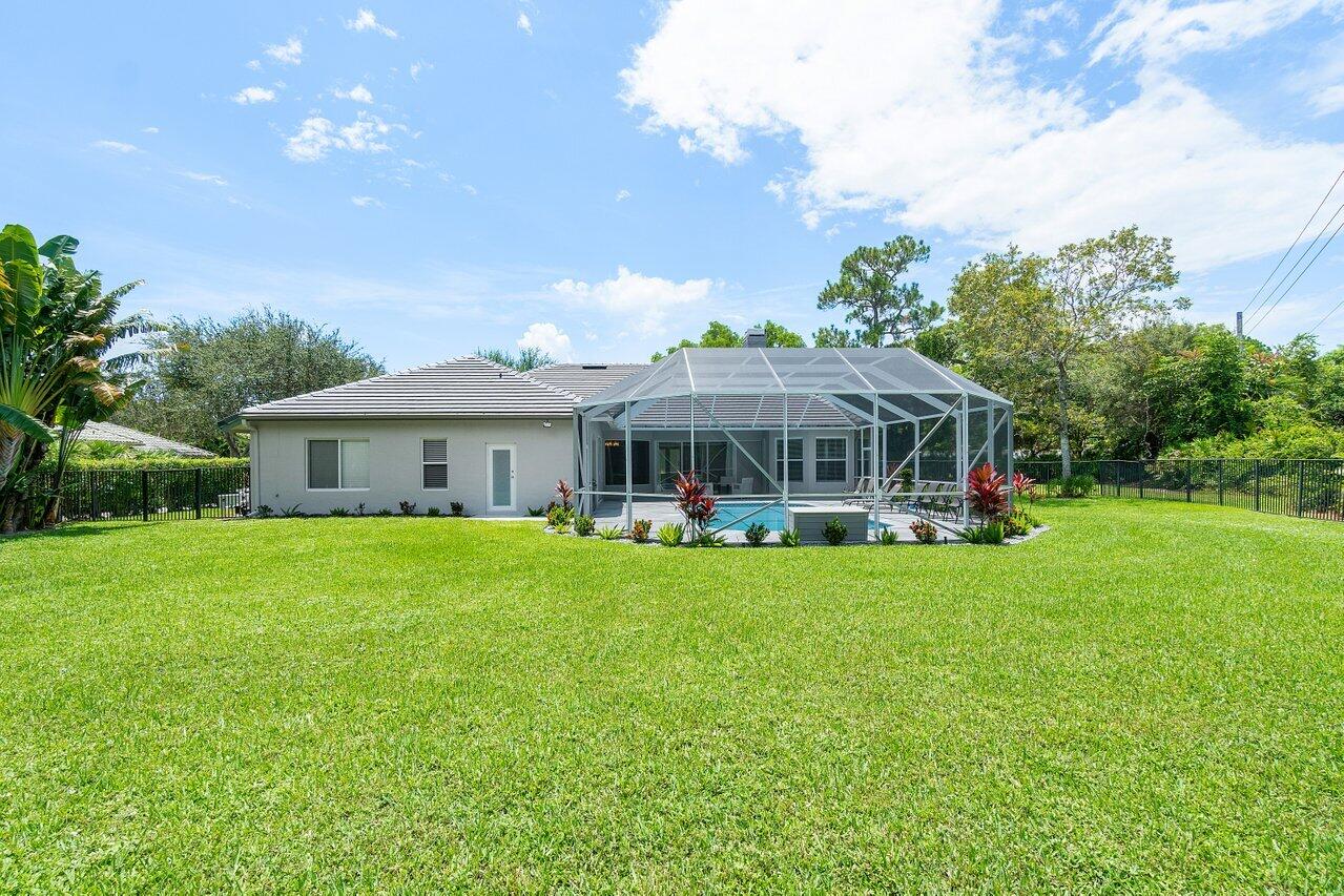 8369 Southeast Island Way Jupiter, FL 33458 - Photo 39 of 41 a front view of house with yard and seating area